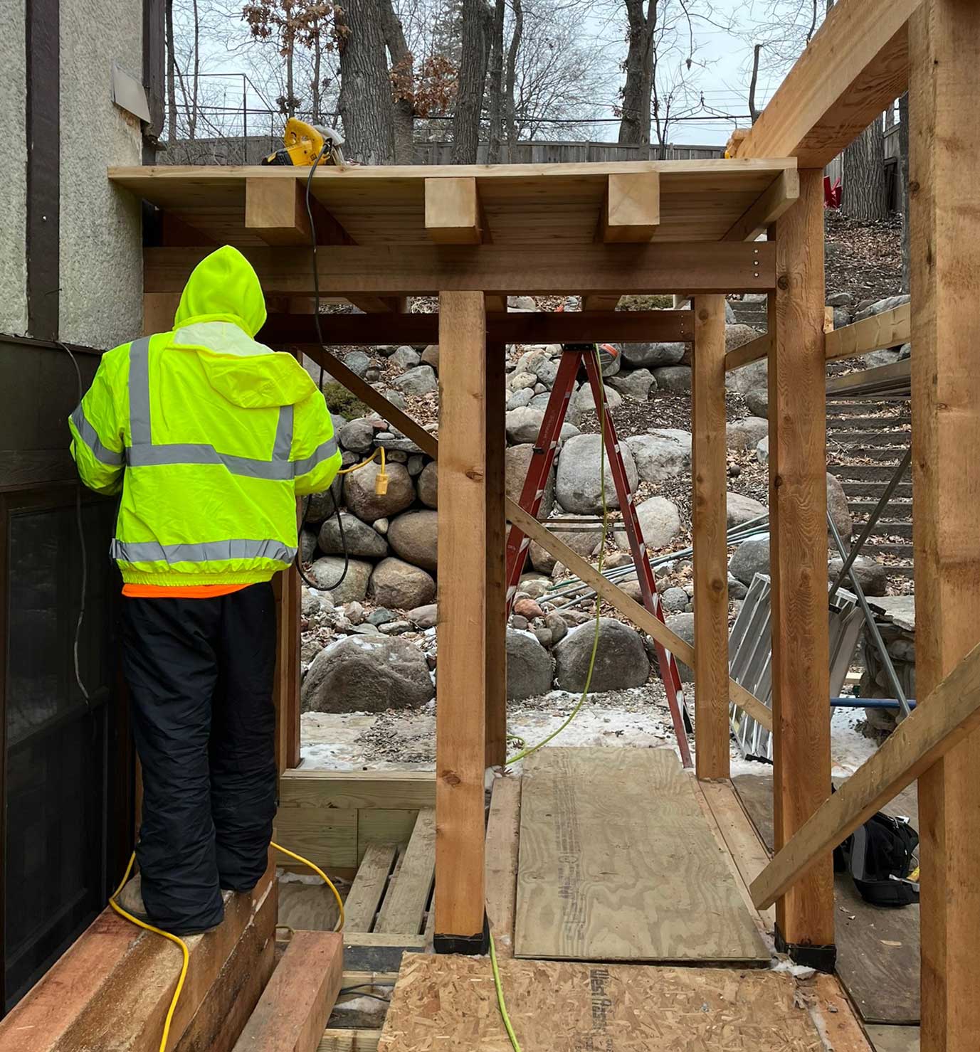 Minnesota Structures builder installing wood posts for porch addition